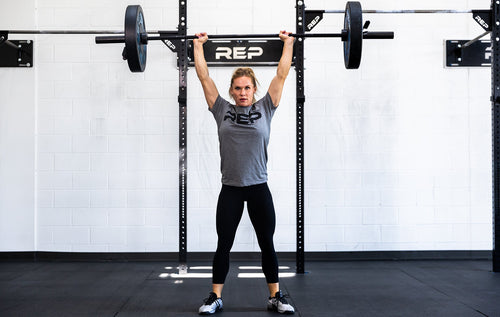 Lifter doing an overhead press with a barbell