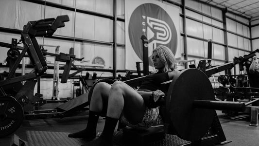 A woman doing hip thrusts in a gym