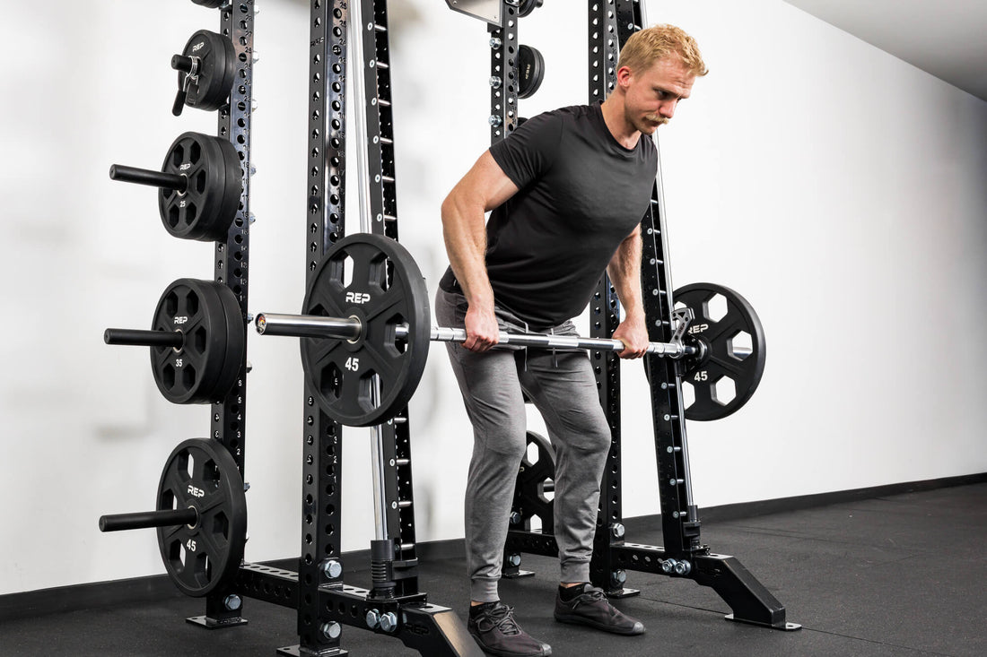Athlete tackles a row while using the REP® Smith Machine attachment.