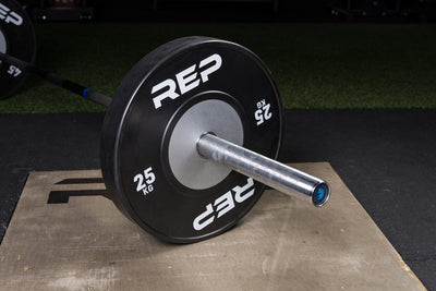 Black Competition Bumper Plates (KG) loaded onto a barbell
