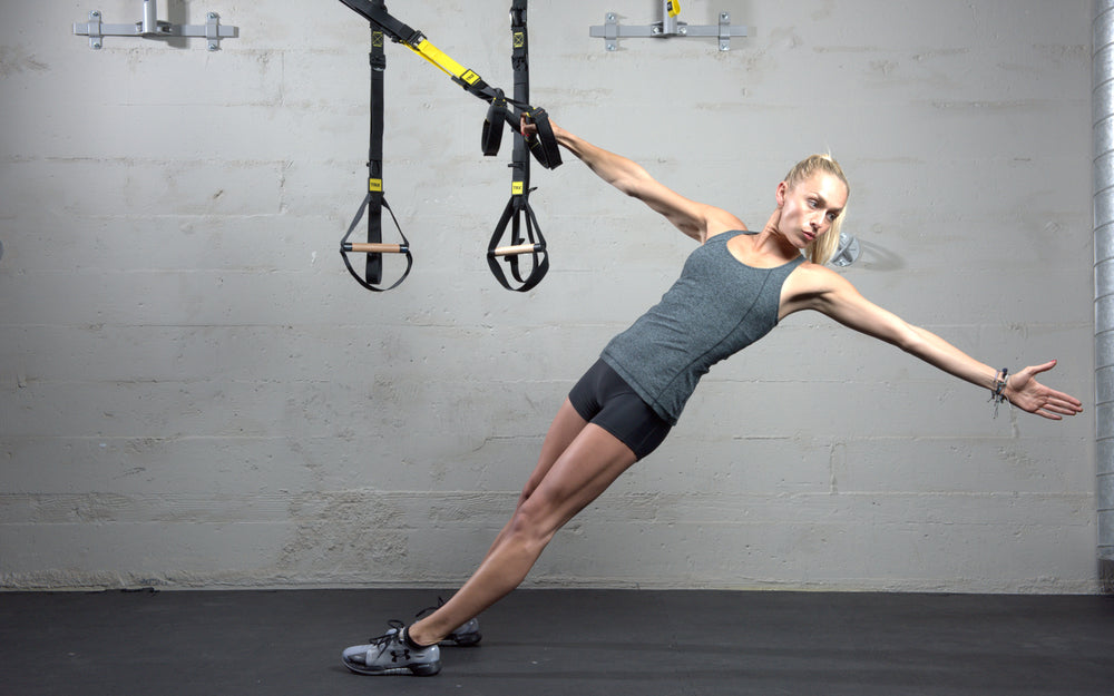 Action shot: Athlete working out on the TRX® CLUB4 in a gym setting