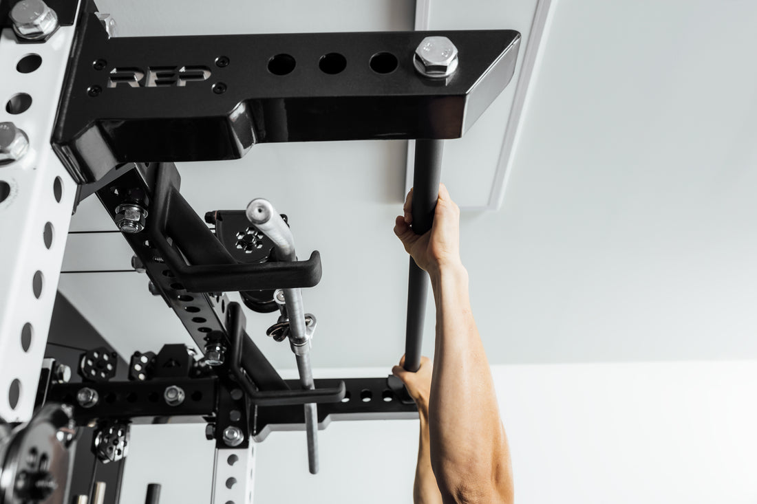 Person performing pull-ups on a pull-up bar (Ares 2.0 4-Post Pull-Up Bar + Pull-Up Bar Extension Brackets).
