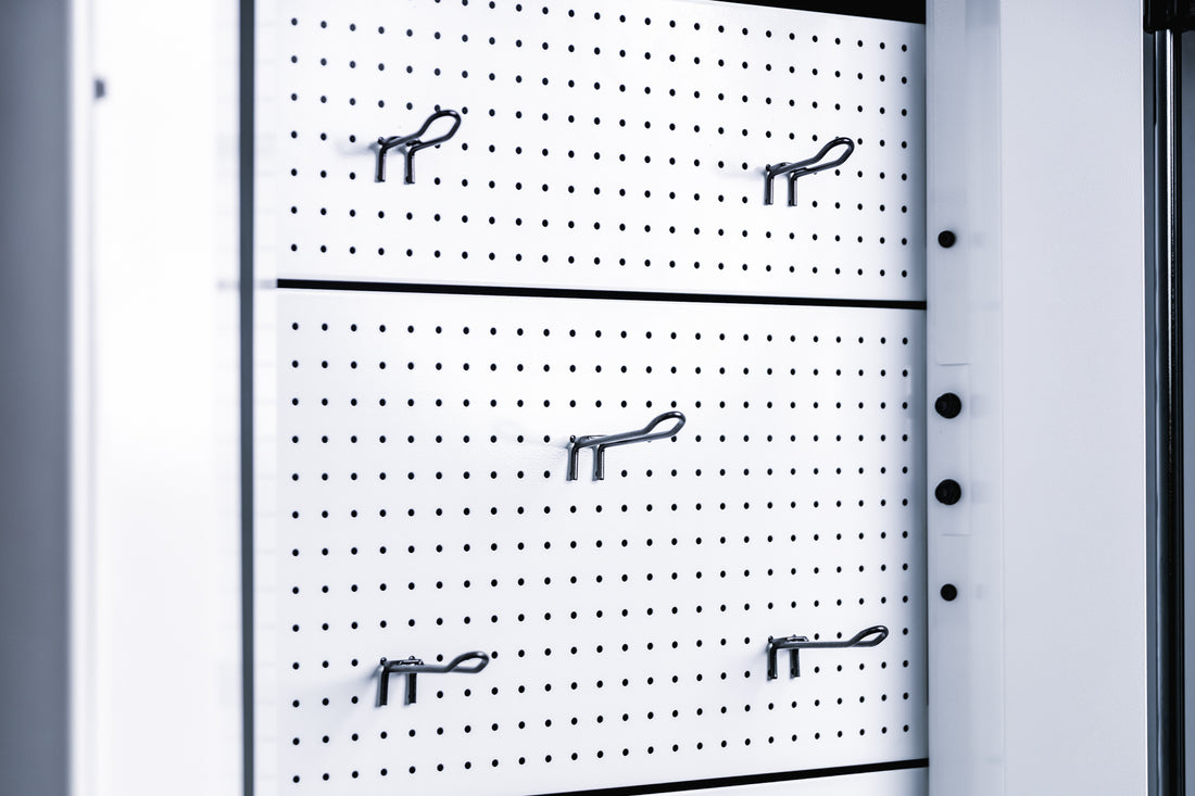 Pegboard storage hooks on a white Arcadia Max