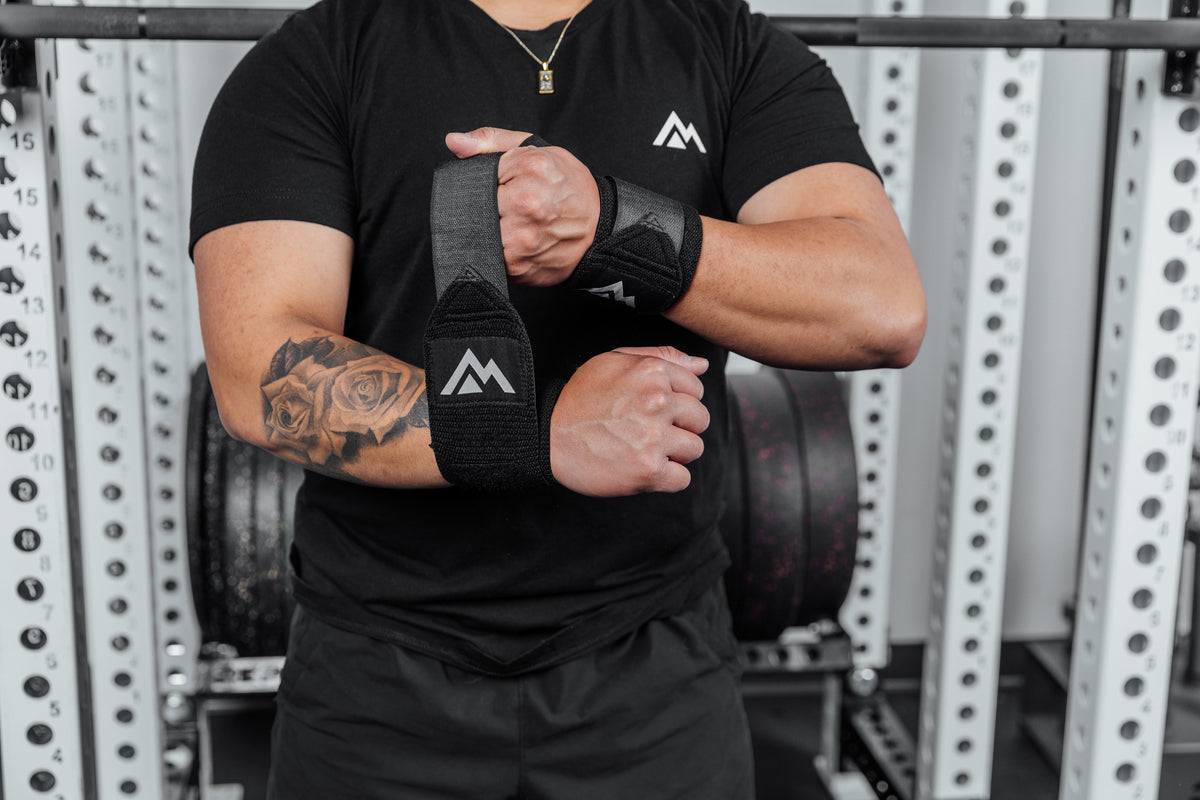 Front shot of an athlete wrapping the REP Wrist Wrap around their wrist
