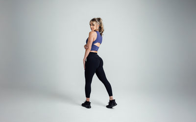 The REP Fitness Women's Rhea Cropped Tank Top in Dusk back, looking over shoulder