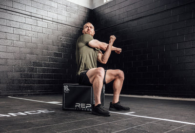 The REP Fitness Men's Sigmatech Shirt in Heather Olive front, stretching