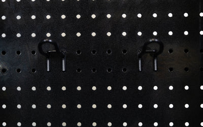 Close-up of pegboard storage hooks on Arcadia Functional Trainer