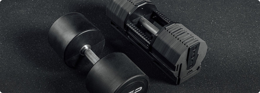 Black dumbbell with digital display on a dark surface