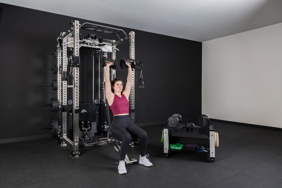 An athlete doing seated shoulder presses with the REP® x PÉPIN™ FAST Series™ Adjustable Dumbbell