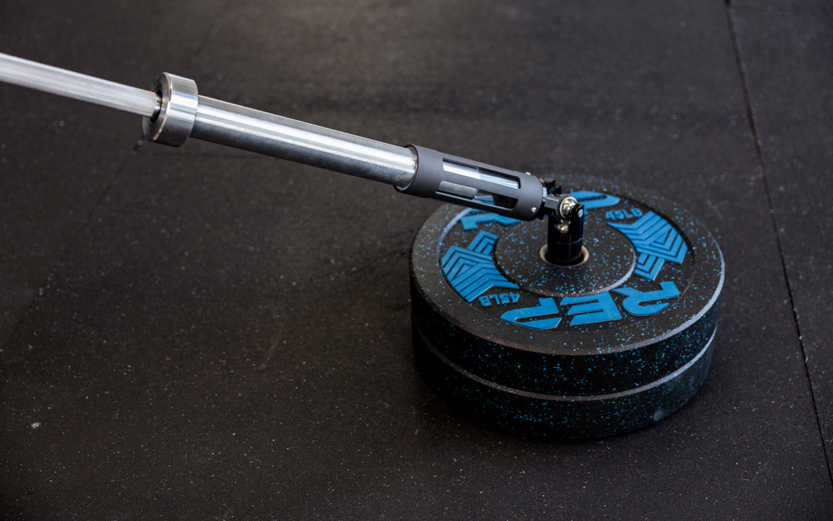 A barbell being slid into the polycarbonate sleeve of the Free Standing REP® x Kleva Built® Adroit Landmine