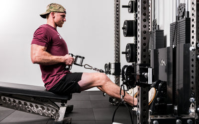 Athlete performing seated low rows with a REP® x Kleva Built® Angled Atlas™ Close-Grip Cable and Landmine Attachment