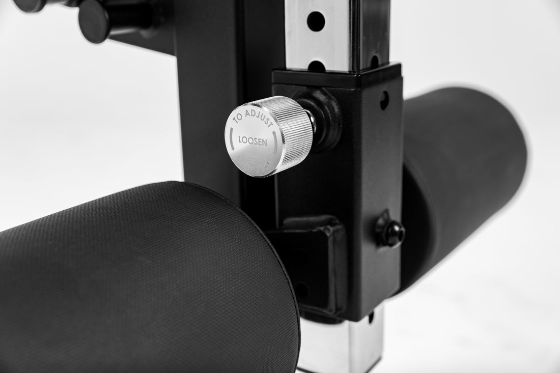 Close-up shot of an adjustment knob on the Leg Extension & Leg Curl Bench Attachment