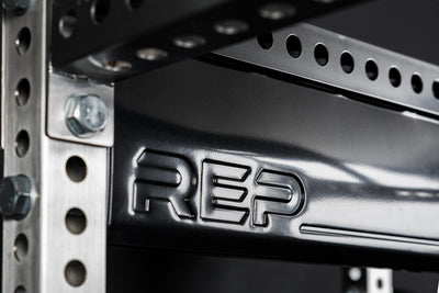 Close-up of metallic black stamped "REP" logo on Logo Plate Crossmember 2.0