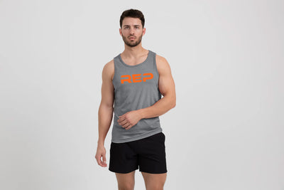 The REP Fitness Men's Daily Driver Tri-Blend Tank in Heather Aluminum/Orange  on body