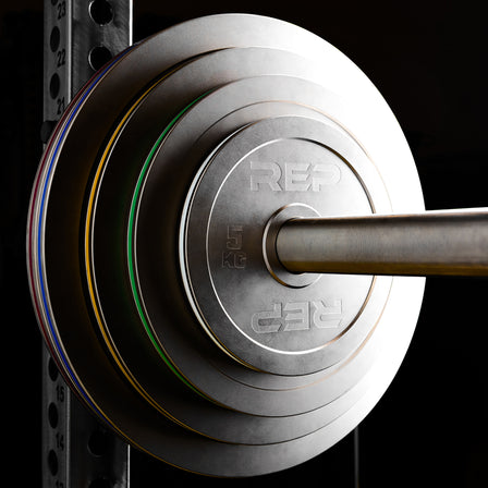 REP Fitness Calibrated Steel Plates in KG loaded onto a barbell on a PR-5000 rack