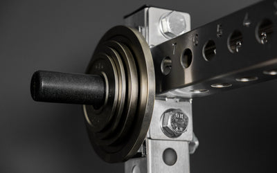 Rep Fitness Calibrated Steel Plates (KG) loaded on a weight horn, highlighting a calibrated tolerance