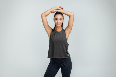 The REP Fitness Women's Peak Cropped Dual-Blend Tank in Heather Charcoal/White on body
