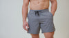 Athlete wearing the REP Fitness Men's Pinnacle Shorts in Olive, Aqua Gray, Black, Cool Gray, Navy