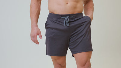 Athlete wearing the REP Fitness Men's Versa Shorts in Heather Black, Heather Cool Gray, Heather Dusty Blue, Slate Blue