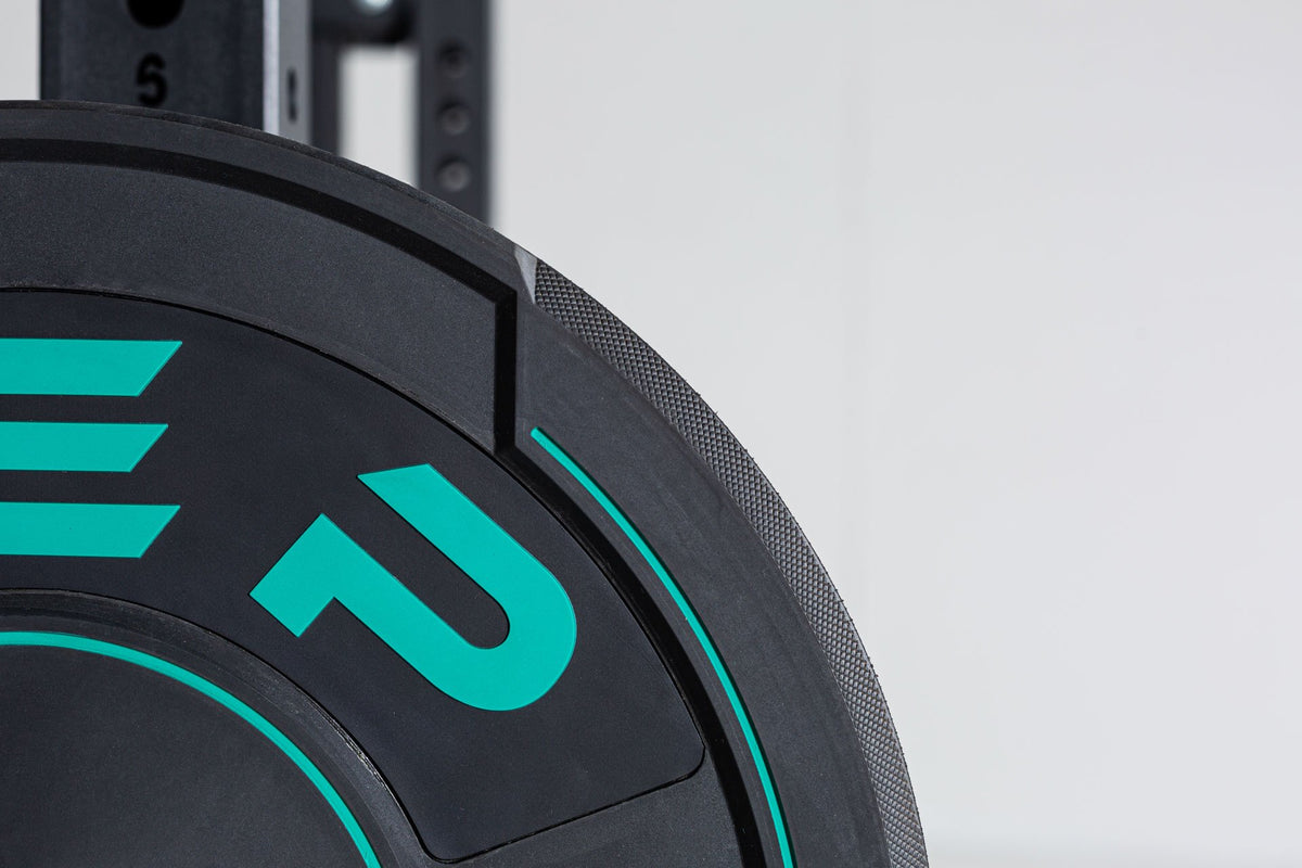 Close-up view of a 25lb sport bumper plate showing the green 