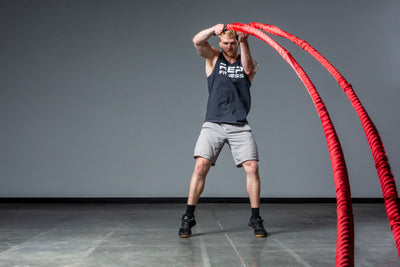Exercising with red Battle Ropes